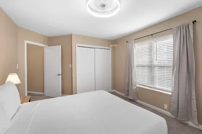 a bedroom with a white bed and a window at Tusculum Hilltop Haven For 8 in Cincinnati