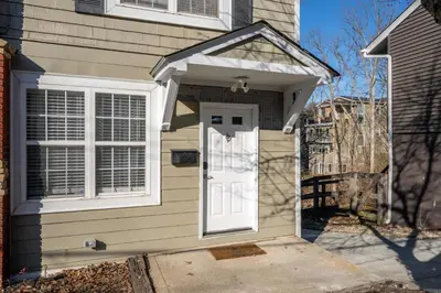 a house with a white door and a window at Tusculum Hilltop Haven For 8 in Cincinnati