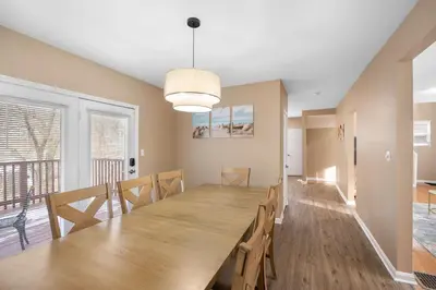 a dining room with a large wooden table and chairs at Tusculum Hilltop Haven For 8 in Cincinnati