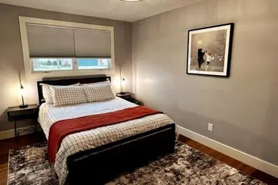 a bedroom with a bed and a picture on the wall at 30 Something Quiet 3BR House Near I-77 & US-250 in New Philadelphia