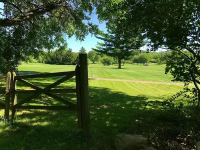 a wooden fence in the middle of a field at Peaceful Cozy 2BR OASIS in Dayton