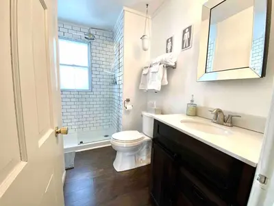 a white bathroom with a toilet and a sink at Peaceful Cozy 2BR OASIS in Dayton