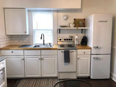 a kitchen with a white refrigerator and a sink at Peaceful Cozy 2BR OASIS in Dayton