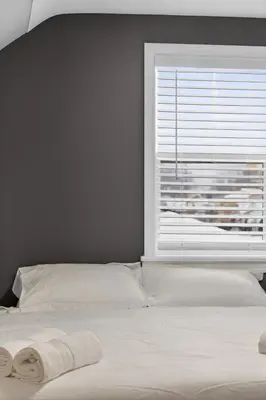 a bedroom with a bed with a window at Stunning Home 15 Min to Downtown & Airport in Parma