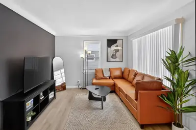 a living room with a couch and a television at Stunning Home 15 Min to Downtown & Airport in Parma