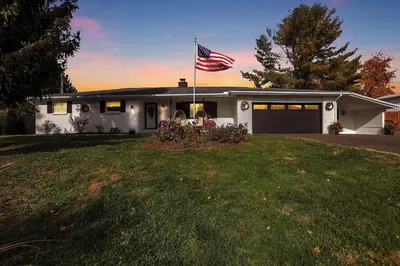 a house with an american flag in the yard at The Nook on the Farm with Pool,Hot tub and Games in Pataskala