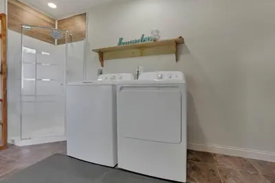 a white washing machine in a bathroom with a shower at The Nook on the Farm with Pool,Hot tub and Games in Pataskala