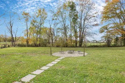 a park with a bench in the middle of a field at The Nook on the Farm with Pool,Hot tub and Games in Pataskala