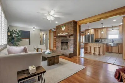 a living room with a couch and a fireplace at The Nook on the Farm with Pool,Hot tub and Games in Pataskala