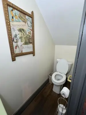 a bathroom with a toilet and a picture on the wall at Historic King House Above The Keep Tavern