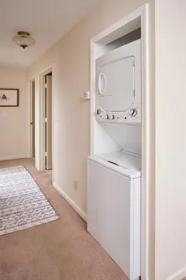 a white laundry room with a washer and dryer at Quiet Guest Space with Hot Tub, Laundry, and Gym in Chagrin Falls