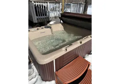 a hot tub in a box in the snow at Quiet Guest Space with Hot Tub, Laundry, and Gym in Chagrin Falls