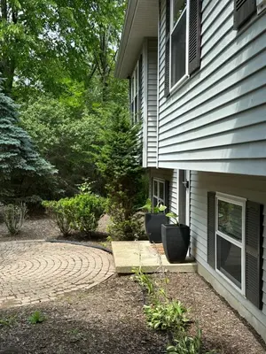 a house with two chairs sitting outside of it at Quiet Guest Space with Hot Tub, Laundry, and Gym in Chagrin Falls