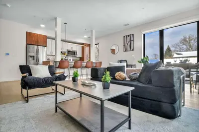 a living room with a couch and a table at CWRU & Little Italy Stay with King Bed Gym Parking WD in Cleveland