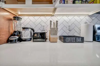 a kitchen counter with a coffee bar sign on it at CWRU & Little Italy Stay with King Bed Gym Parking WD in Cleveland