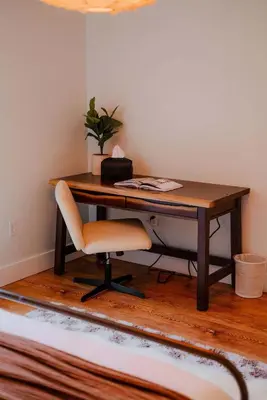 a desk with a chair in a room at The 312 House| A Boho Retreat| Hocking Hills in Logan