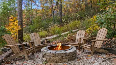 two chairs and a fire pit in a yard at The Hummingbird - Mountaintop Cabin with Hot Tub in Stanton