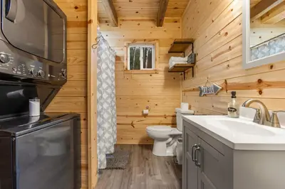 a wooden bathroom with a toilet and a sink at The Hummingbird - Mountaintop Cabin with Hot Tub in Stanton
