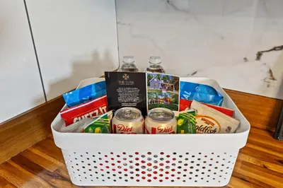 a basket filled with drinks and books on a table at 2 Hot Tubs/Private Bar/ Pickleball & Basketball Ct in Georgetown