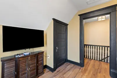 a living room with a large flat screen tv at 2 Hot Tubs/Private Bar/ Pickleball & Basketball Ct in Georgetown