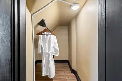 a white shirt hanging on a hanger in a hallway at 2 Hot Tubs/Private Bar/ Pickleball & Basketball Ct in Georgetown