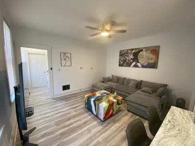 a living room with a couch and a tv at Brand new home just minutes from downtown Cincinnati in Cincinnati