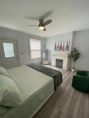 a bedroom with a large bed and a fireplace at Brand new home just minutes from downtown Cincinnati in Cincinnati