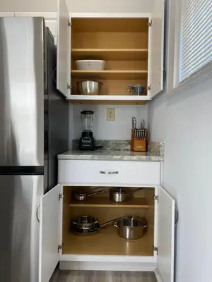 a kitchen with white cabinets and pots and pans at Brand new home just minutes from downtown Cincinnati in Cincinnati