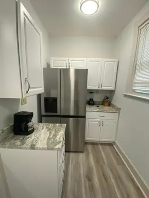 a kitchen with white cabinets and a stainless steel refrigerator at Brand new home just minutes from downtown Cincinnati in Cincinnati