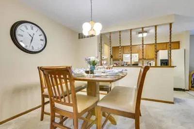 a dining room with a table and a clock on the wall at Great for Travel Nurses! Home 4 Mi to Dtwn Troy in Troy