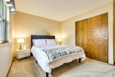 a bedroom with a large bed and a wooden door at Great for Travel Nurses! Home 4 Mi to Dtwn Troy in Troy