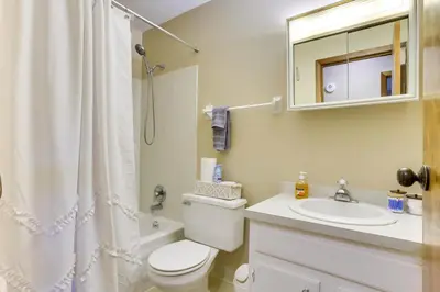 a bathroom with a toilet and a sink and a mirror at Great for Travel Nurses! Home 4 Mi to Dtwn Troy in Troy