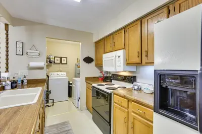a kitchen with wooden cabinets and white appliances at Great for Travel Nurses! Home 4 Mi to Dtwn Troy in Troy