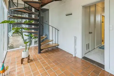 a hallway with a staircase and a potted plant at Mt Adams Lookout with Best City View and Parking in Cincinnati