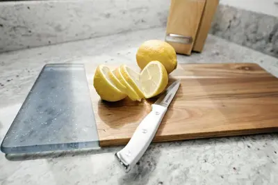 a cutting board with a knife and lemons on it at Mt Adams Lookout with Best City View and Parking in Cincinnati