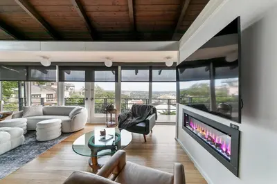a living room with a large flat screen tv at Mt Adams Lookout with Best City View and Parking in Cincinnati