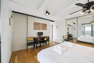 a bedroom with a bed and a desk with a computer at Mt Adams Lookout with Best City View and Parking in Cincinnati