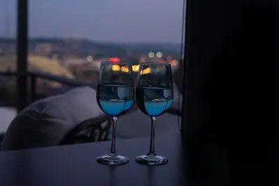 two wine glasses sitting on a table with a view at Mt Adams Lookout with Best City View and Parking in Cincinnati
