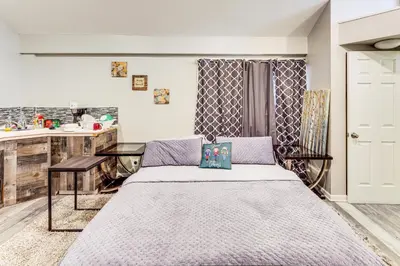 a bedroom with a bed and a table in it at 8 Mi to Dtwn CLE Cozy Couples Retreat with Gym! in Cleveland