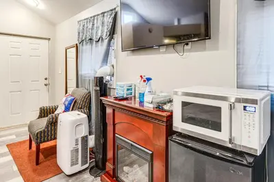 a kitchen with a microwave and a desk with a microwave at 8 Mi to Dtwn CLE Cozy Couples Retreat with Gym! in Cleveland