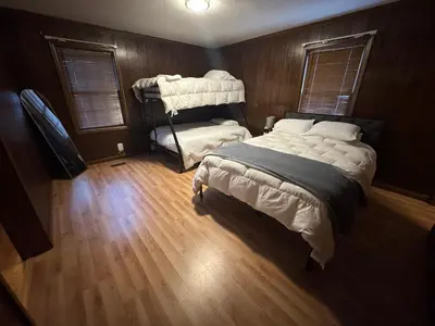 a bedroom with a bed and a wooden floor at Prime 1BR- Minutes to Toledo, Sylvania and MI in Toledo