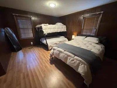 a bedroom with a large bed and a wooden floor at Prime 1BR- Minutes to Toledo, Sylvania and MI in Toledo