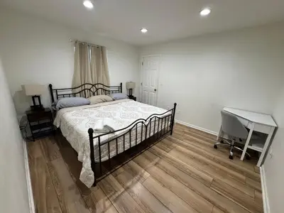 a bedroom with a bed and a desk in it at Spacious 2BR Apartment near Toledo, Sylvania & MI in Toledo