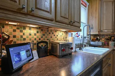 a kitchen with a sink and a computer on a counter at Cozy Berrodin Bed And Breakfast Whole House Booking In Highland Square Akron in Akron