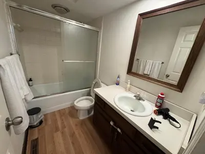 a bathroom with a sink and a toilet and a mirror at Modern 2BR Suite 202- Toledo & Sylvania Gateway in Toledo