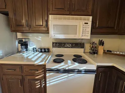 a kitchen with a stove and a microwave at Modern 2BR Suite 202- Toledo & Sylvania Gateway in Toledo