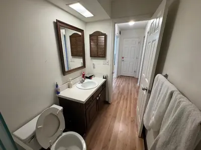 a bathroom with a sink and a toilet and a mirror at Modern 2BR Suite 202- Toledo & Sylvania Gateway in Toledo