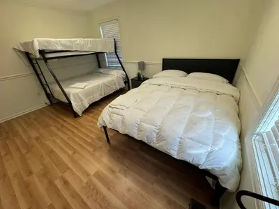 a bedroom with a bed and a bunk bed at Modern 2BR Suite 202- Toledo & Sylvania Gateway in Toledo