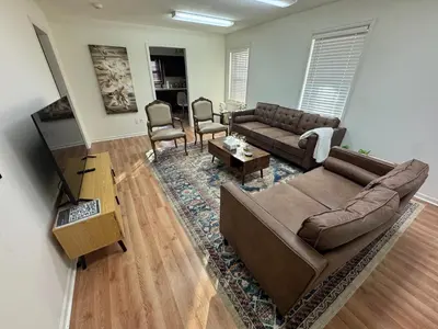 a living room with a couch and a table at Modern 2BR Suite 202- Toledo & Sylvania Gateway in Toledo