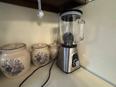 a blender sitting on top of a counter with three jars at Modern 2BR Suite 202- Toledo & Sylvania Gateway in Toledo